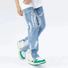 Dressed in the Y2K Patchwork Baggy Flare Jeans in Blue from the Kanye Streetwear Store, a person showcases their style with green and white sneakers. The emphasis is on their trendy lower-body ensemble against a plain white background.