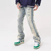 A person wearing the Ropa Grunge Y2K Hole Ripped Baggy jeans in Washed Blue by Kanye Streetwear Store, paired with a dark jacket and trendy green and white sneakers. The plain white background highlights their bold fashion statement.