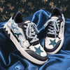 The Vexlly Men Casual Sneakers Trend Skateboard Flat Outdoor Shoes boast a stylish design with blue and teal star patterns resting on silky blue fabric. These sneakers feature blue laces and artistic patterns in white, black, and blue tones, offering a unique look that's perfect for comfortable walking or as trendy skateboard shoes.