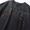 The Velvet Underground Vintage Graphic Tee by Vexlly is a black shirt featuring "VELVET" in large, drippy letters across the back. The vintage-inspired design showcases a gradient effect, transitioning from white to orange at the bottom.