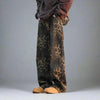 A person is wearing Vexlly Leopard Print Jeans, a stylish pair of fashion retro wide-leg jeans, complemented by a brown oversized hoodie and tan shoes. With the focus on the lower body against a plain background, consulting an Asian size chart might be advisable for an accurate fit.