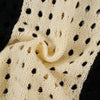 Close-up of the Hoodie Cross Patchwork Hollow Sweater from My Store, featuring a cream-colored openwork pattern with black accents. The soft texture and knit design create a series of small holes, enhancing its intricate style. Note that hand measurement might subtly affect size chart recommendations.