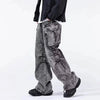 A person highlights Y2K fashion in Vexlly's 2024 Ropa Aesthetic Y2K Fashion vintage grey baggy cargo jeans pants, which feature a pleated streetwear design, paired with a black jacket and matching sneakers, standing sideways against a plain background.