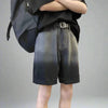 A person wearing Vexlly's Summer Gradient Denim Shorts Men's Fashion Retro Denim Shorts, paired with a loose black T-shirt and a large black backpack, stands with their arms crossed against a plain gray background. The outfit, inspired by the Asian size chart, captures casual comfort and sleek styling.