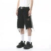 A person wearing a white t-shirt, the *Shorts en Jean Déchiré à Rayures Latérales pour Homme* from the ELKMU Official Store with distressed details and chains, a black belt, white socks, and black sneakers. The unique design of the shorts highlights the différence de couleur against the plain white background.