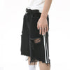 A person wearing the Shorts en Jean Déchiré à Rayures Latérales pour Homme from the ELKMU Official Store—black distressed shorts with white stripes on the sides—and a matching white T-shirt, complemented by a black belt. They accessorize with stylish rings that perfectly enhance their look, standing confidently with one hand at their side. The ensemble subtly highlights a taille that defines their silhouette.