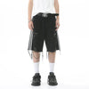 Someone is dressed in a white T-shirt, ELKMU Official Store's Shorts en Jean Déchiré à Rayures Latérales pour Homme characterized by distressed black fabric and white side stripes with chains, complemented by a black belt featuring a silver buckle, white socks, and black sneakers. The plain white background accentuates the subtle différence de couleur in the outfit's details.