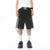 Someone is dressed in a white T-shirt, ELKMU Official Store's Shorts en Jean Déchiré à Rayures Latérales pour Homme characterized by distressed black fabric and white side stripes with chains, complemented by a black belt featuring a silver buckle, white socks, and black sneakers. The plain white background accentuates the subtle différence de couleur in the outfit's details.