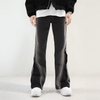 A person is positioned against a plain background, highlighting the Split Zipper Baggy Flare Jeans in Vintage Black from the Kanye Streetwear Store. These jeans feature prominent white side seams and are paired with white shoes. The product description emphasizes their unique vintage fade and wide leg opening. Their upper body is partially visible, creating an effect similar to peering through a window.