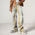 The individual is wearing a brown jacket, oversized Y2K Washed Blue Old Baggy Stacked Jeans from Kanye Streetwear Store with unique stitching, and a "Maison Prance" belt, complemented by brown and white sneakers. The backdrop is minimalistic.