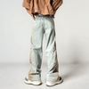 A person in the Y2K Washed Blue Old Baggy Stacked Jeans from Kanye Streetwear Store stands facing away, wearing an oversized brown jacket. Their white sneakers contrast with the minimalist, light gray space, crafting a stark yet stylish silhouette.