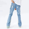 In a minimalist white setting, someone models the Y2K Patchwork Baggy Flare Jeans in Blue, featuring chic paint splatters. With one leg positioned slightly outwards, they exude a laid-back yet fashionable vibe.