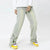 Clad in the Washed Blue Ankle Zipper Jeans from Kanye Streetwear Store, a person sporting a white long-sleeve shirt and colorful yellow and purple sneakers poses against a plain white backdrop.